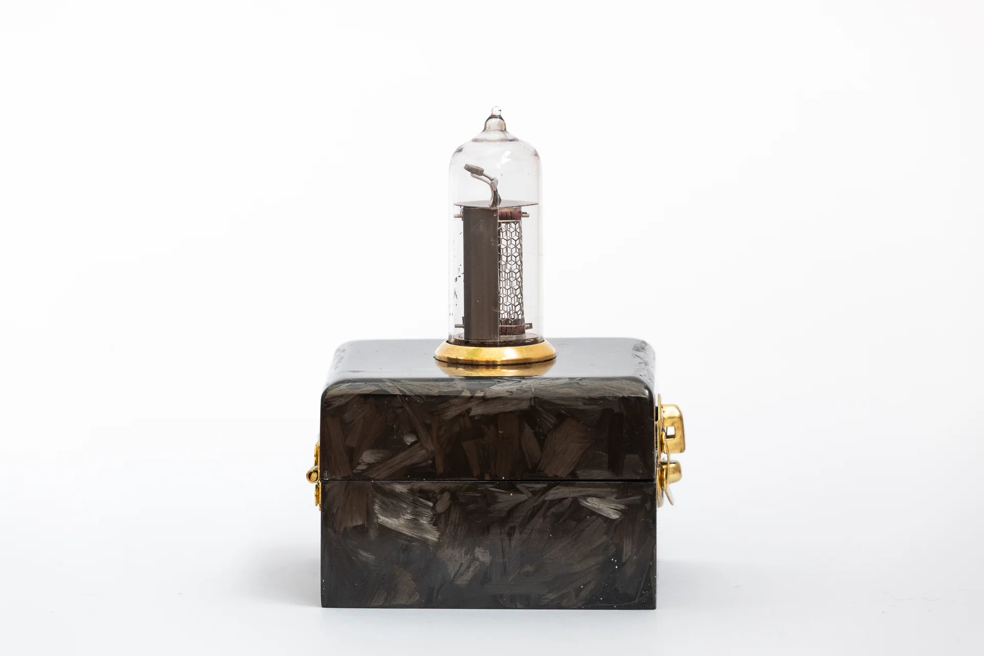 Side view of carbon fiber nixie clock enclosure with brass hardware